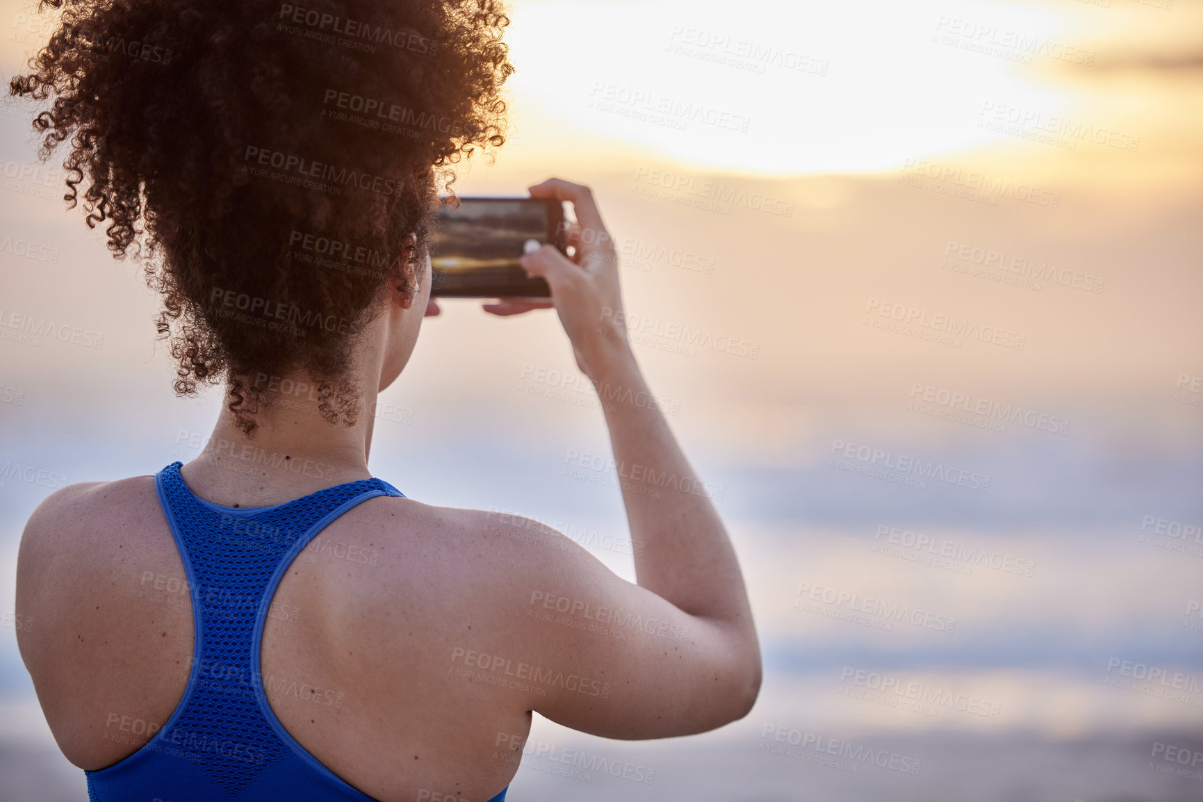 Buy stock photo Phone screen, photography and woman with beach sunset for travel, memory or running fitness break. Sunrise, back and runner smartphone for social media, blog and profile picture at sea for training