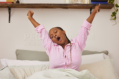 Buy stock photo Shot of a young woman waking up and stretching in bed at home