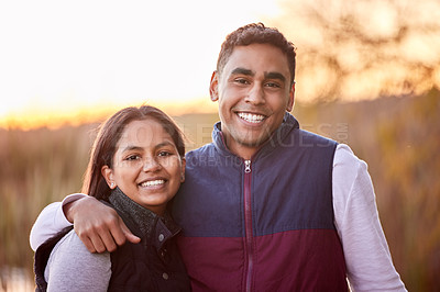 Buy stock photo Shot of a young couple having a good time outside while camping outside