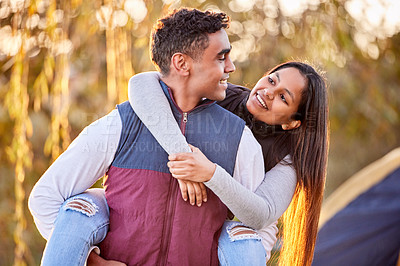 Buy stock photo Shot of a young couple having a good time outside while camping outside