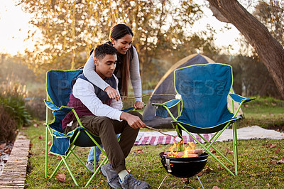 Buy stock photo Fire, camping and couple with marshmallows in nature for romantic vacation, adventure or holiday. Love, happy and young man and woman roasting candy by flame on outdoor weekend trip together.