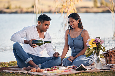 Buy stock photo Picnic, man and woman with champagne, glass and romantic date for anniversary outdoors. Love, happy couple and alcohol in park for relax, celebrate and bonding in relationship with snack in nature