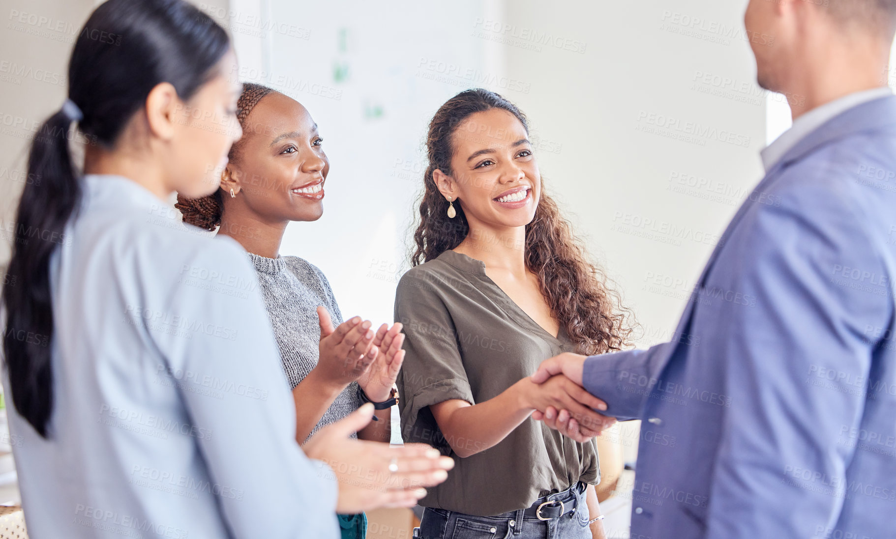 Buy stock photo Shot of a young businesswoman shaking hands with a colleague in an office at work