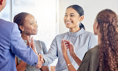 Buy stock photo Shot of a young businesswoman shaking hands with a colleague in an office at work