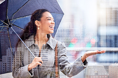 Buy stock photo Shot of a young businesswoman carrying an umbrella outside