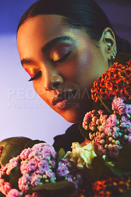 Buy stock photo Neon, woman and bouquet of flowers in studio for beauty, cosmetics and makeup. Face, female person and pride by backdrop for glow, art deco and foundation with floral for aesthetic and luxury