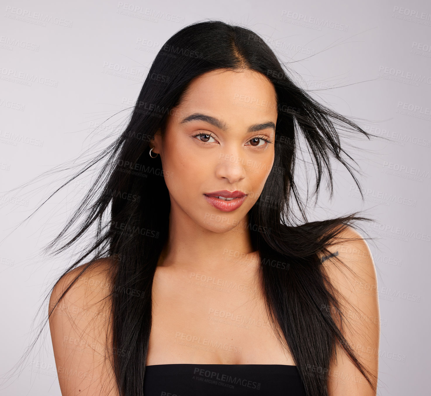 Buy stock photo Studio shot of a beautiful young woman posing against a grey background