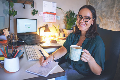 Buy stock photo Shot of an attractive young woman sitting and enjoying a cup of coffee while writing notes in her home office