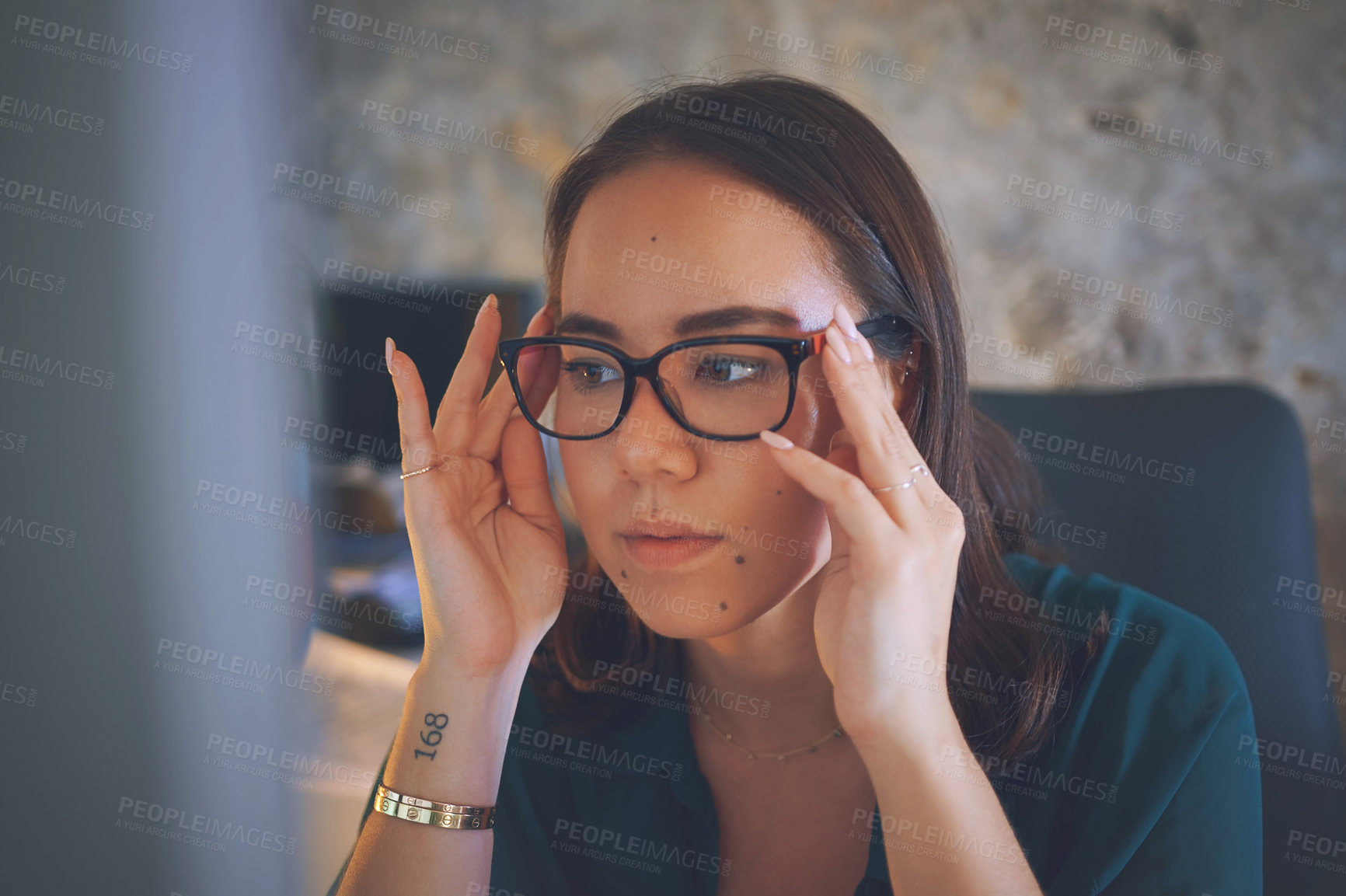 Buy stock photo Shot of an attractive young woman sitting alone and feeling stressed while working from home