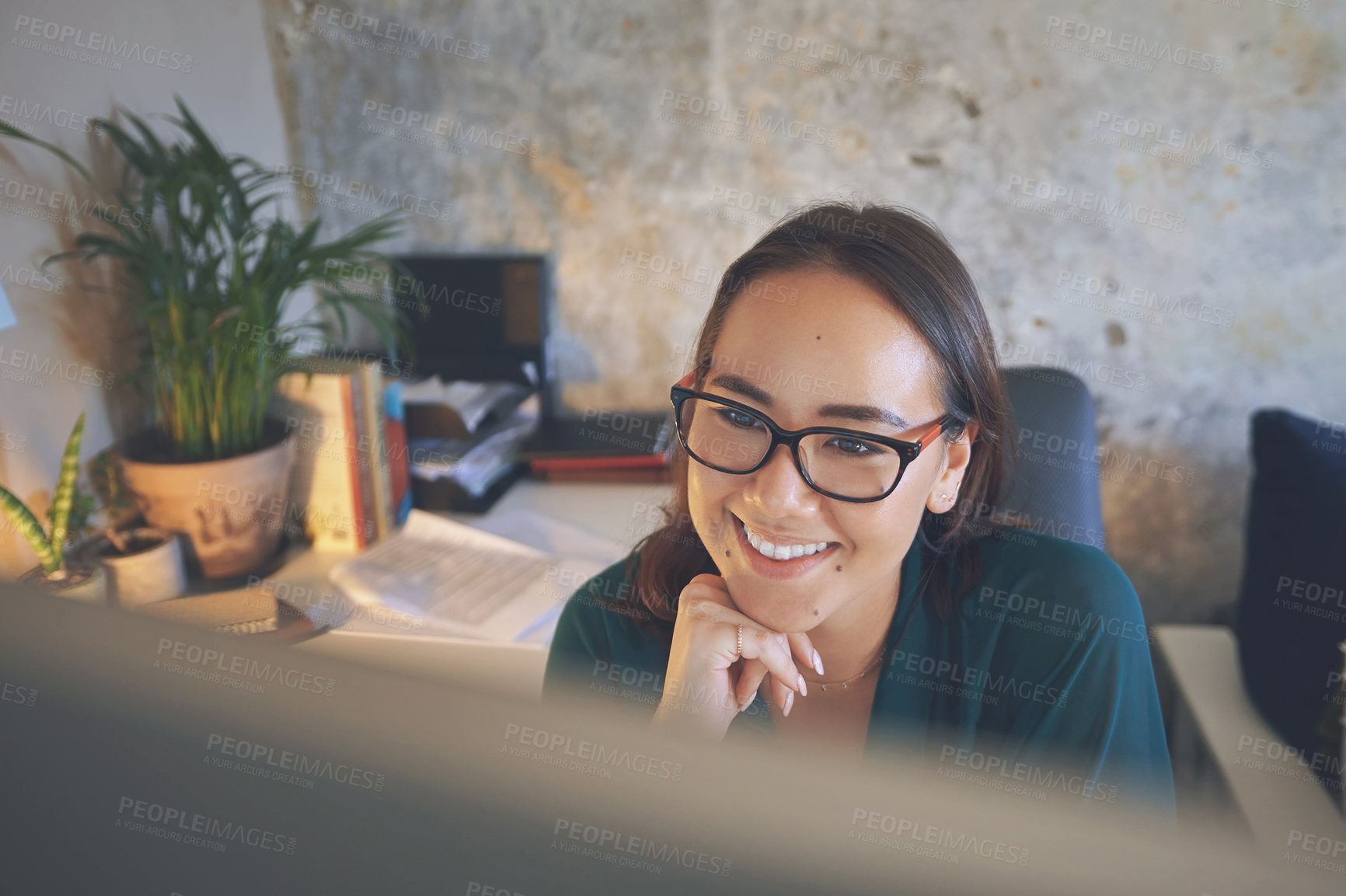 Buy stock photo Shot of an attractive young woman sitting alone and using her computer to work from home