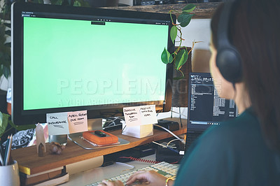 Buy stock photo Cropped shot of an unrecognizable woman sitting alone and wearing a headset while using her computer to work from home