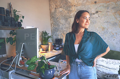 Buy stock photo Shot of an attractive young woman standing alone in her home office during the day