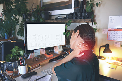 Buy stock photo Shot of an unrecognizable woman sitting alone and suffering from neck ache while working from home