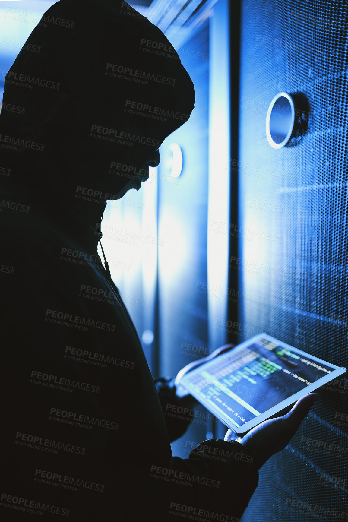 Buy stock photo Shot of a hacker using a digital tablet in a server room