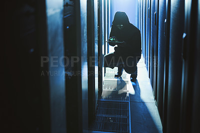 Buy stock photo Shot of a hacker using a digital tablet in a server room