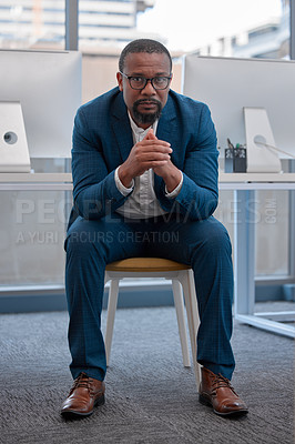 Buy stock photo Shot of a young man sitting in a modern office