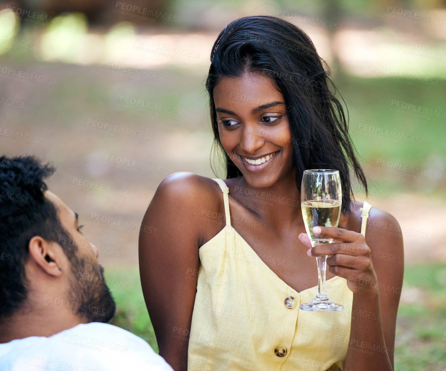 Buy stock photo Couple, champagne and smile in nature for summer vacation, relax and happiness for relationship. Indian, happy and celebration, man and woman in park with drinks for love, romance or anniversary date