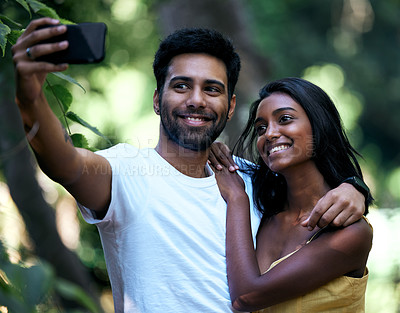 Buy stock photo Shot of a young couple taking a selfie while out on a date