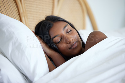 Buy stock photo Shot of a beautiful young woman sleeping peacefully in her bed