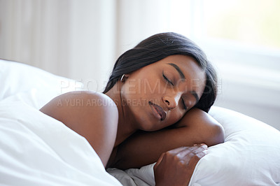 Buy stock photo Shot of a beautiful young woman sleeping peacefully in her bed