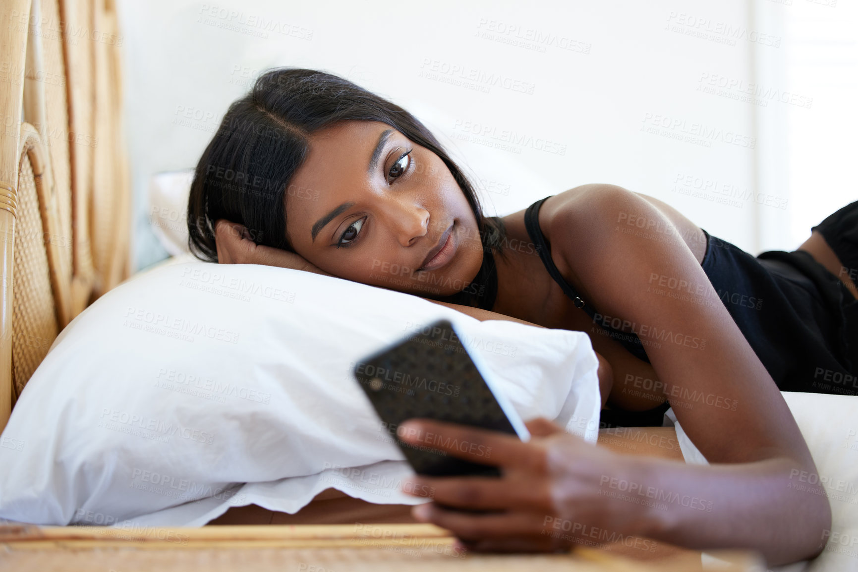 Buy stock photo Smartphone, woman and reading in bed for online news with pillow, social media and communication. Indian gen z girl, mobile contact and chat app on mattress with scroll on internet and notification