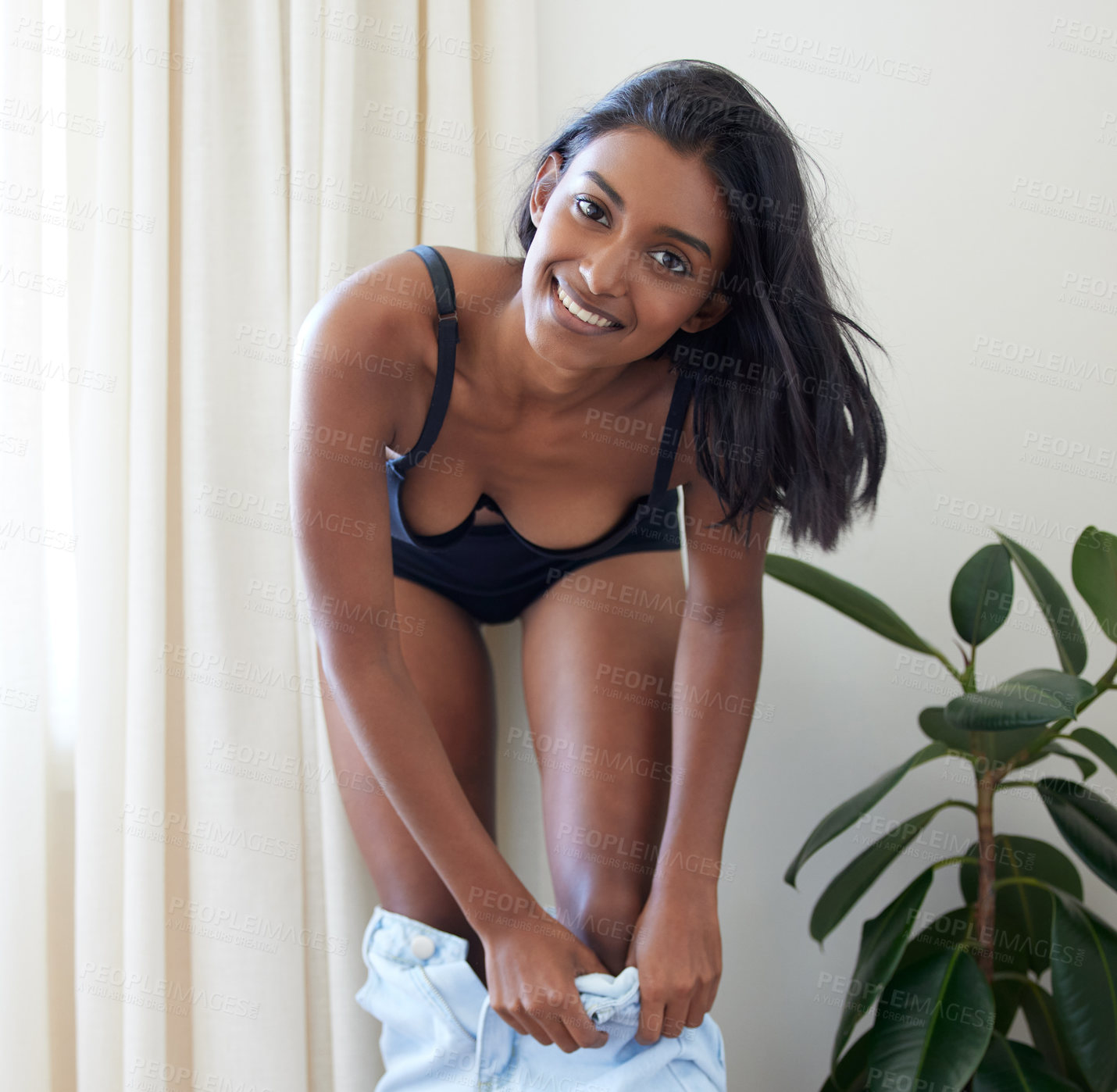 Buy stock photo Shot of a beautiful young woman getting dressed