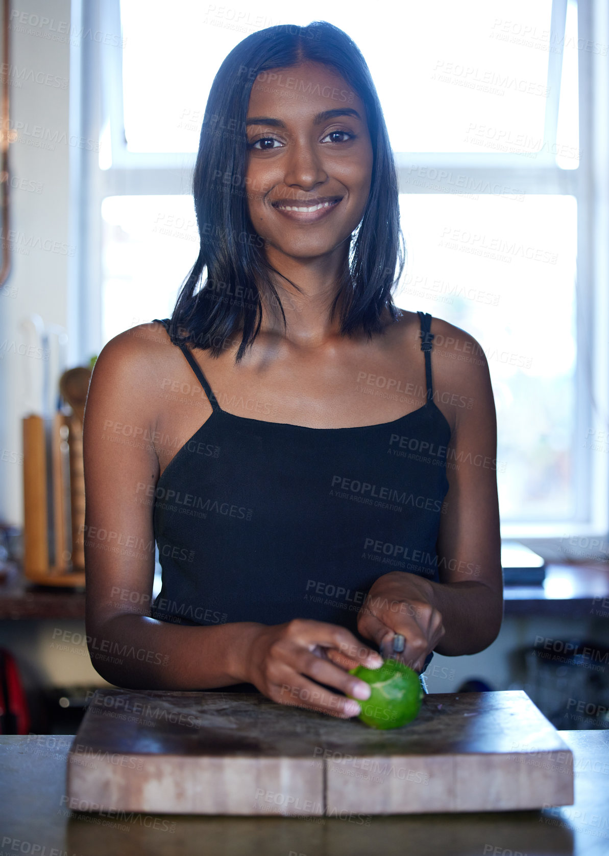 Buy stock photo Woman, portrait and cutting fruit in kitchen for diet, smile and healthy eating in Sri Lanka. Female person, lime and preparing for juice, smoothie and home for morning routine or weight loss