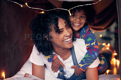 Buy stock photo Shot of a woman and her son being playful at home