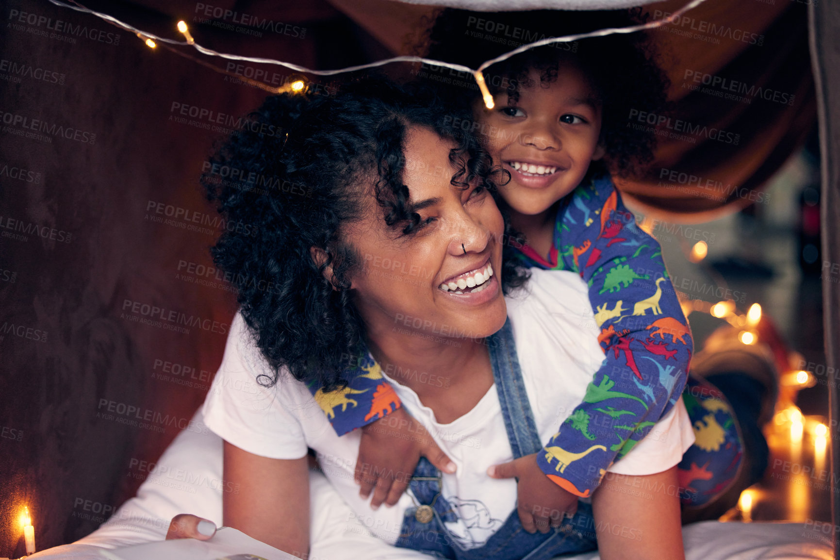 Buy stock photo Shot of a woman and her son being playful at home