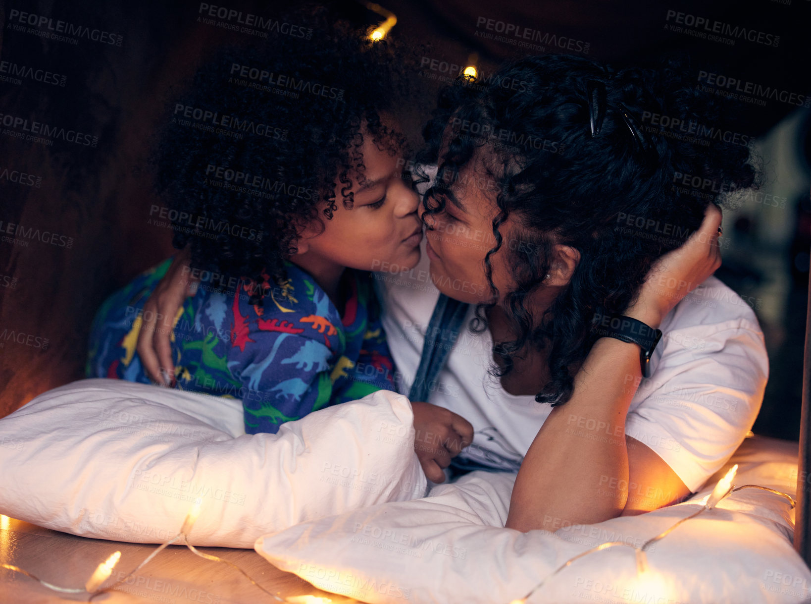 Buy stock photo Shot of a little boy kissing his mother goodnight