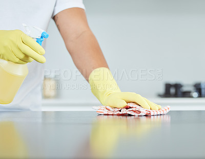 Buy stock photo Shot of a man cleaning the counter in his kitchen