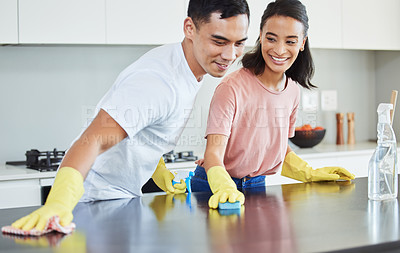 Buy stock photo Shot of a young couple cleaning their kitchen together