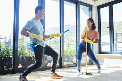 Buy stock photo Couple, singing and cleaning home, dance and having fun playing with mop guitar and broom. Clean, dancing and happy man and woman, singer and chores, housekeeping together and happiness for music.