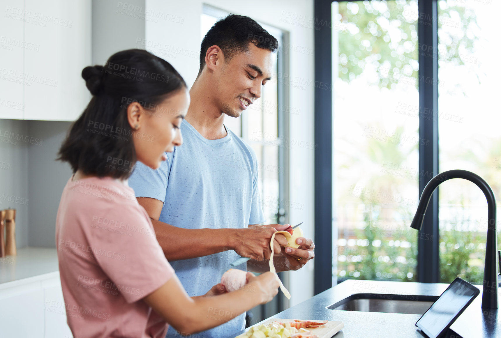 Buy stock photo Health, fruit and couple in kitchen with knife for organic diet, protein smoothie and vitamin c. Happy woman, peeling food and man in apartment for citrus milkshake with apple, energy and nutrition