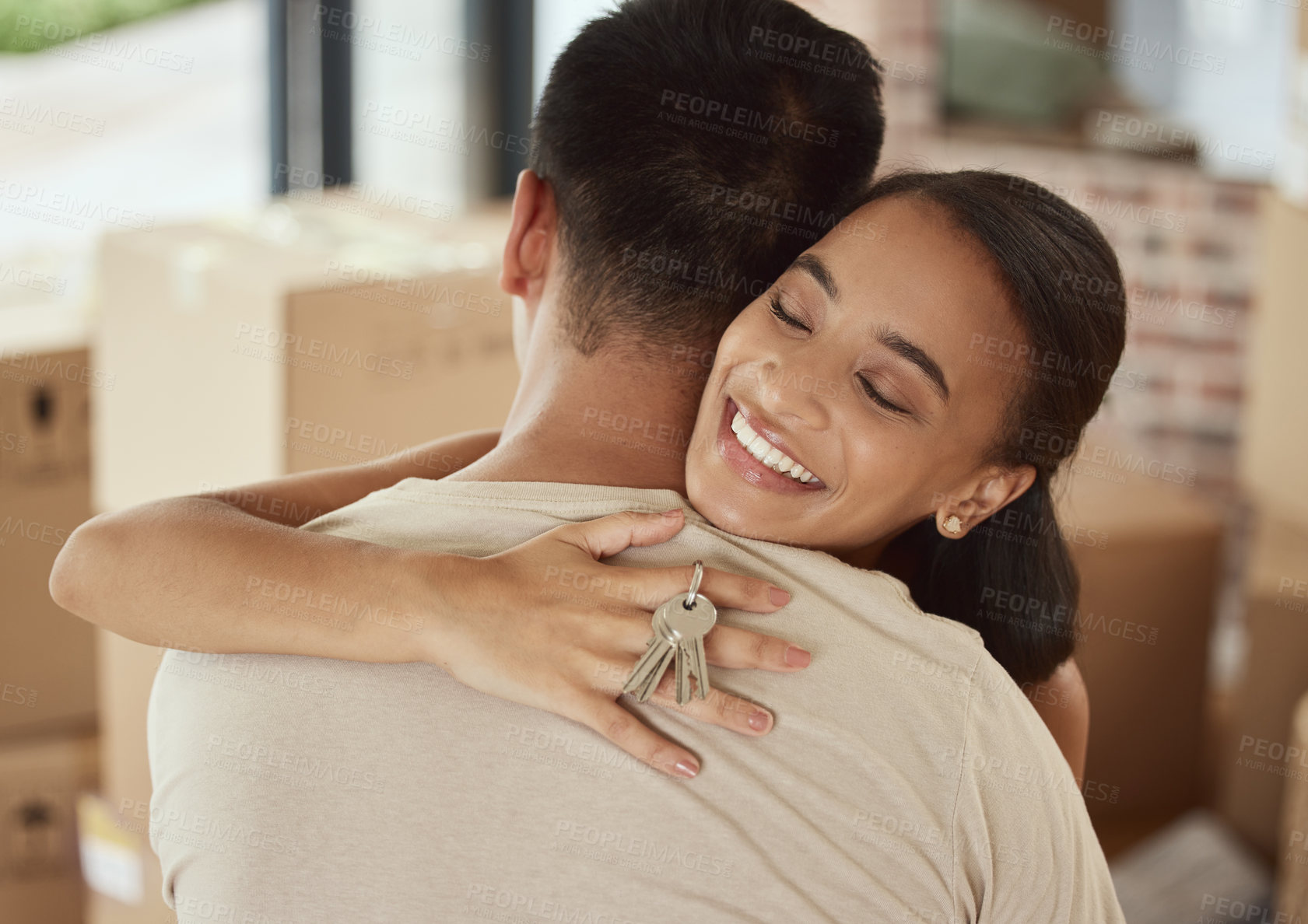 Buy stock photo Couple, new home and happy hug with key, property investment or purchase and mortgage with partners. Ownership, together and relationship achievement with house goal, boxes or real estate celebration