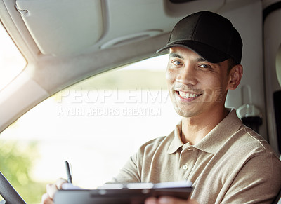 Buy stock photo Shot of a delivery man checking the paperwork for his delivery in his car