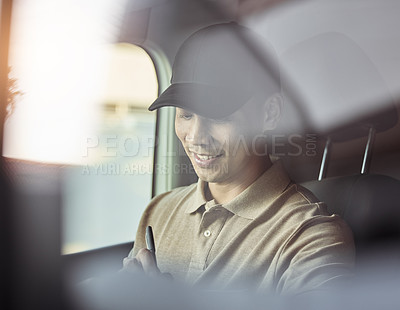 Buy stock photo Shot of a delivery checking his deliveries before dropping them off