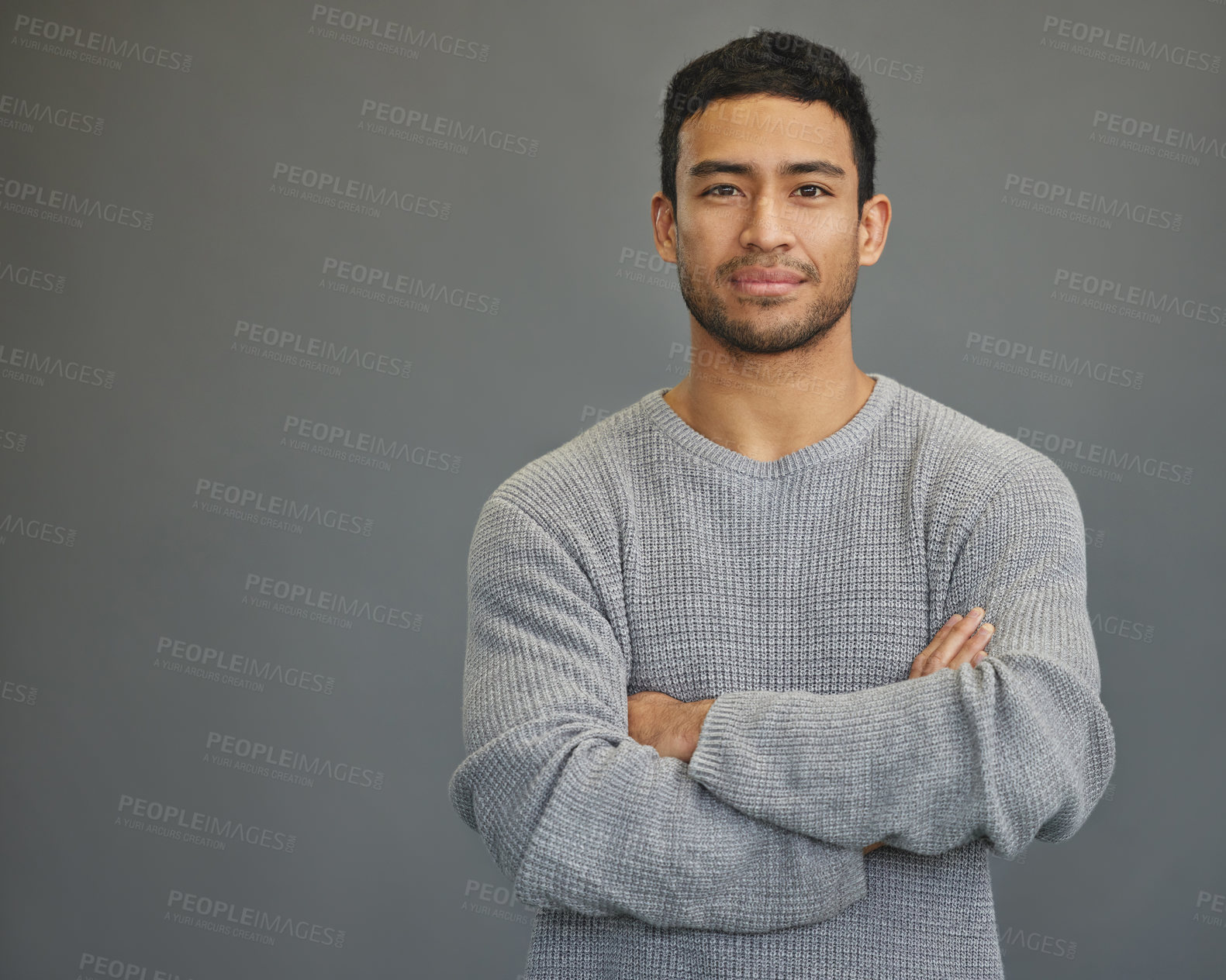 Buy stock photo Portrait of man in studio with mockup space, arms crossed and confident smile on studio backdrop in casual fashion. Relax, confidence and face of male on grey background with focus, pride and mock up