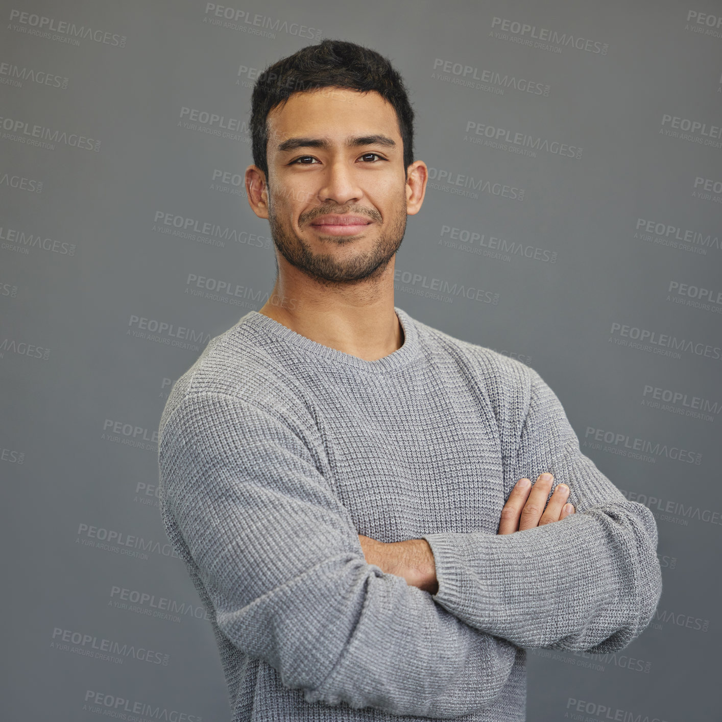 Buy stock photo Portrait of happy man with mockup, arms crossed and ideas on studio backdrop in casual fashion. Relax, confidence and face of male on grey background with happiness, pride and smile with promo space.