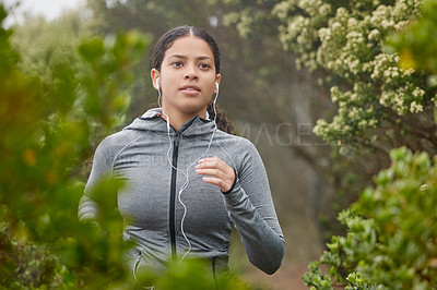 Buy stock photo Shot of a young woman running in nature