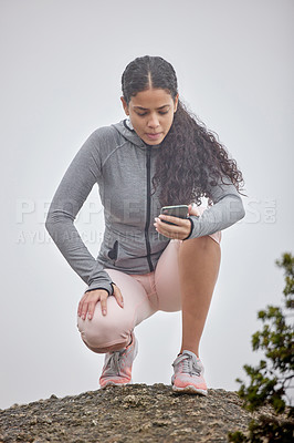 Buy stock photo Mountain, hiking and woman exercise with phone to check stats or time of workout in nature. Runner, app and girl with smartphone to measure progress in training with stop watch, timer or health data