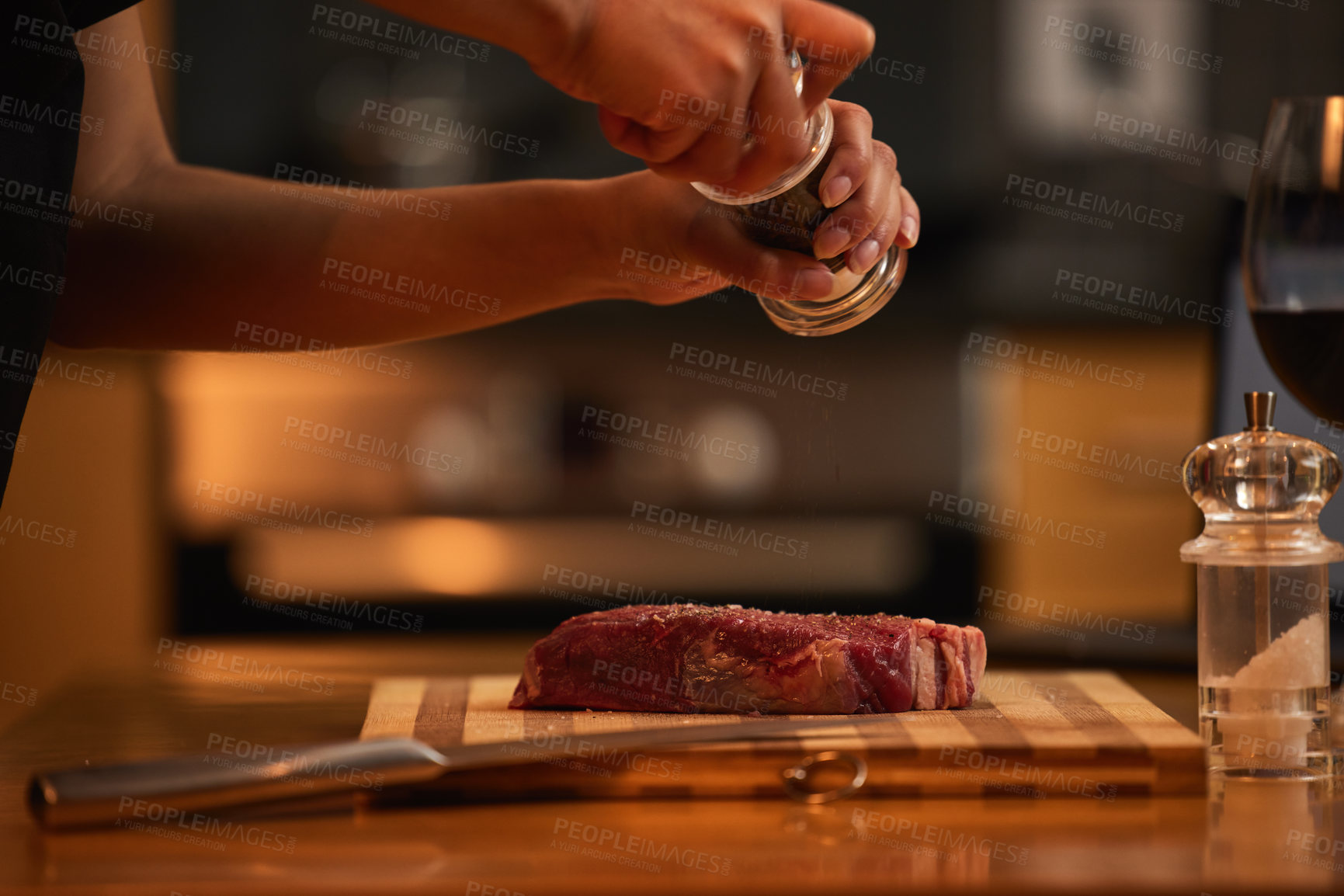 Buy stock photo Shot of a woman seasoning a piece of steak for dinner