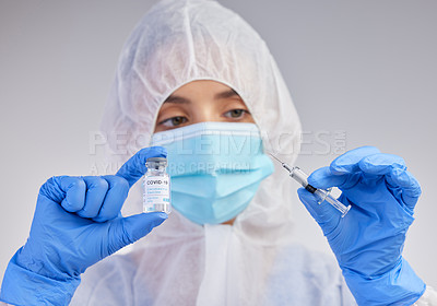 Buy stock photo Ppe, covid 19 vaccine and nurse with syringe and mask on for safety or medication in white studio background. Danger, healthcare worker or female person in scrubs for viral defence and protection