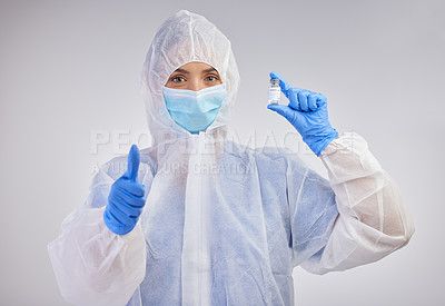 Buy stock photo Shot of a female nurse holding a vaccination vial against a studio background