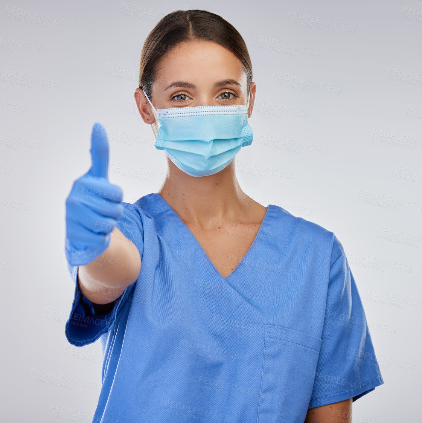 Buy stock photo Mask, nurse and woman with thumbs up, portrait and studio for safety, yes and thank you for healthcare. White background, medical and person in mockup, professional and healthy in clinic and expert