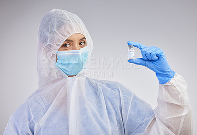Buy stock photo Shot of a female nurse holding a vaccination vial against a studio background