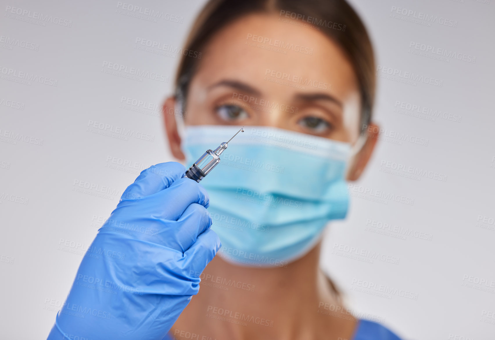 Buy stock photo Ppe, nurse or doctor with needle for vaccination, safety and medical practice in white studio background. Danger, healthcare worker or female person in scrubs for viral defence and protection