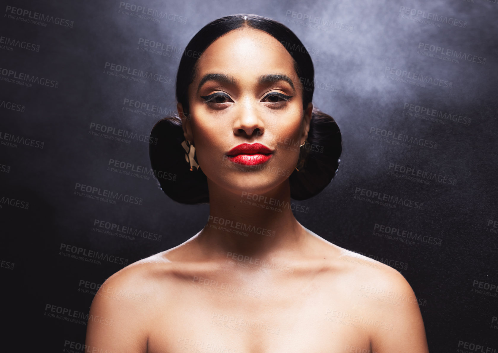 Buy stock photo Shot of an attractive young woman posing against a black background in the studio