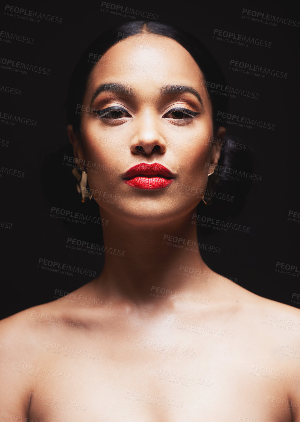 Buy stock photo Shot of an attractive young woman posing against a black background in the studio