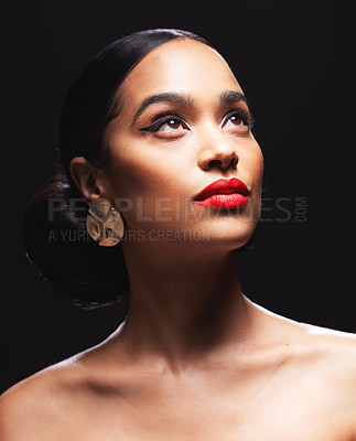 Buy stock photo Shot of an attractive young woman posing against a black background in the studio